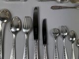a lot of silver spoons and forks on the table