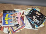 a pile of magazines on the floor next to a wall