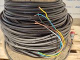 a pile of wires on a pallet with a sign in the background