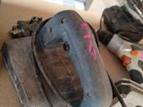 a dirty helmet sitting on top of a desk next to a computer