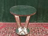 a small table with a glass top on a rug