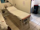 a room with a bed and a sink in it
