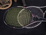 two tennis racquets laying on the ground next to each other