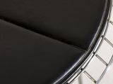 black leather seat on a chrome steel wire chair in a living room