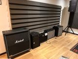 two amps and two speakers in a room