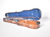 a violin case that is open on a white surface