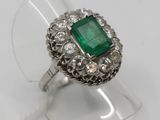 an image of a close up of a ring with a green stone on it