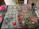 a lot of glasses on the table with pink stuff in them