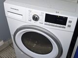 a washer and dryer in the corner of a room
