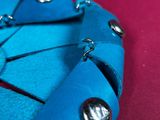 a close up of a blue origami piece of paper