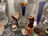 many different glass vases sitting on a glass table