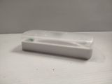 a plastic container with a toothbrush in it on a table