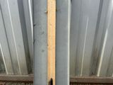a metal box with a wooden handle on the ground