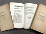 three open books sitting on top of a table next to each other