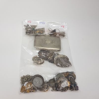 a bag of silver and gold coins on a white table