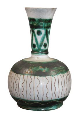 a green and white vase sitting on a white surface