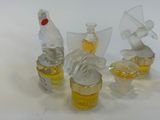 four glass figurines of different shapes and sizes on a white surface