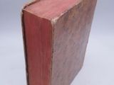 a red book sitting on top of a white table