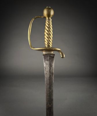 a gold and silver sword on a black background