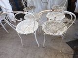 four chairs and a table in a room with white curtains