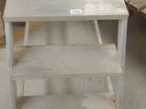 a table that has a shelf on top of it