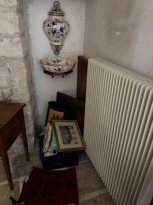 a radiator in the corner of a room next to a table