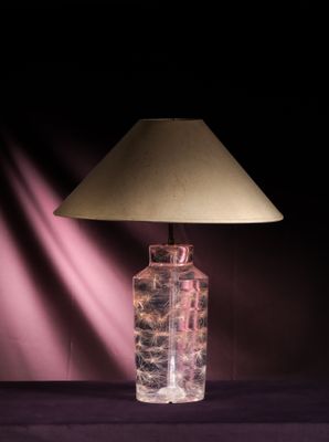 a lamp that is sitting on a table with a shade on it