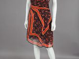 a mannequin wearing a dress with an orange and black print