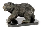 a statue of a bear on a black marble base