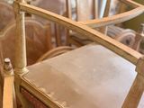 a chair that is sitting next to a bed