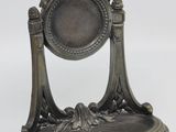 a silver statue of a mirror with birds on it
