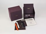 a purple box with a pen and a notepad in it