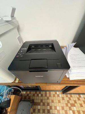 a printer sitting on top of a desk next to a printer