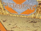 an orange and silver sign on the side of a yellow fire hydrant