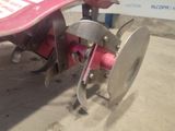 a pink skateboard that is attached to a pink machine
