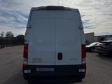 the back end of a white van parked in a parking lot