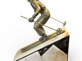 statue of a skier on a marble base on a white background