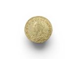 a close up of a gold coin on a white surface