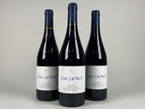 three bottles of wine sitting on top of a table
