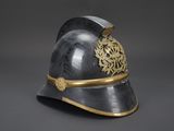 an old helmet with a gold decoration on the side