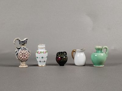 five small vases sitting next to each other on a table