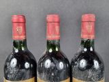 three bottles of wine sitting on top of a table next to each other