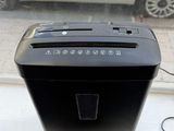 a black paper shredder sitting on a window sill