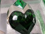 a green heart shaped object in a clear box
