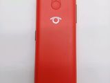 the back of a red cell phone with a white eye on it