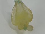 a small yellow flower shaped object on a white surface