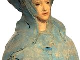 a statue of a woman with a bird on her head