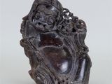 une vieille statue représentant un homme tenant une fleur à la main