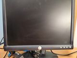 a computer monitor sitting on a desk with a mouse and keyboard