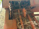 an image of a tractor with hay in the back